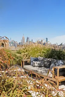 a view of a patio with couches table and chairs and potted plants