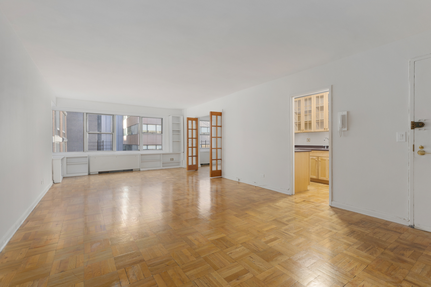 136 East 56th Street, Unit 9J Manhattan, NY 10022 - Photo 6 of 14 a view of an empty room with a window