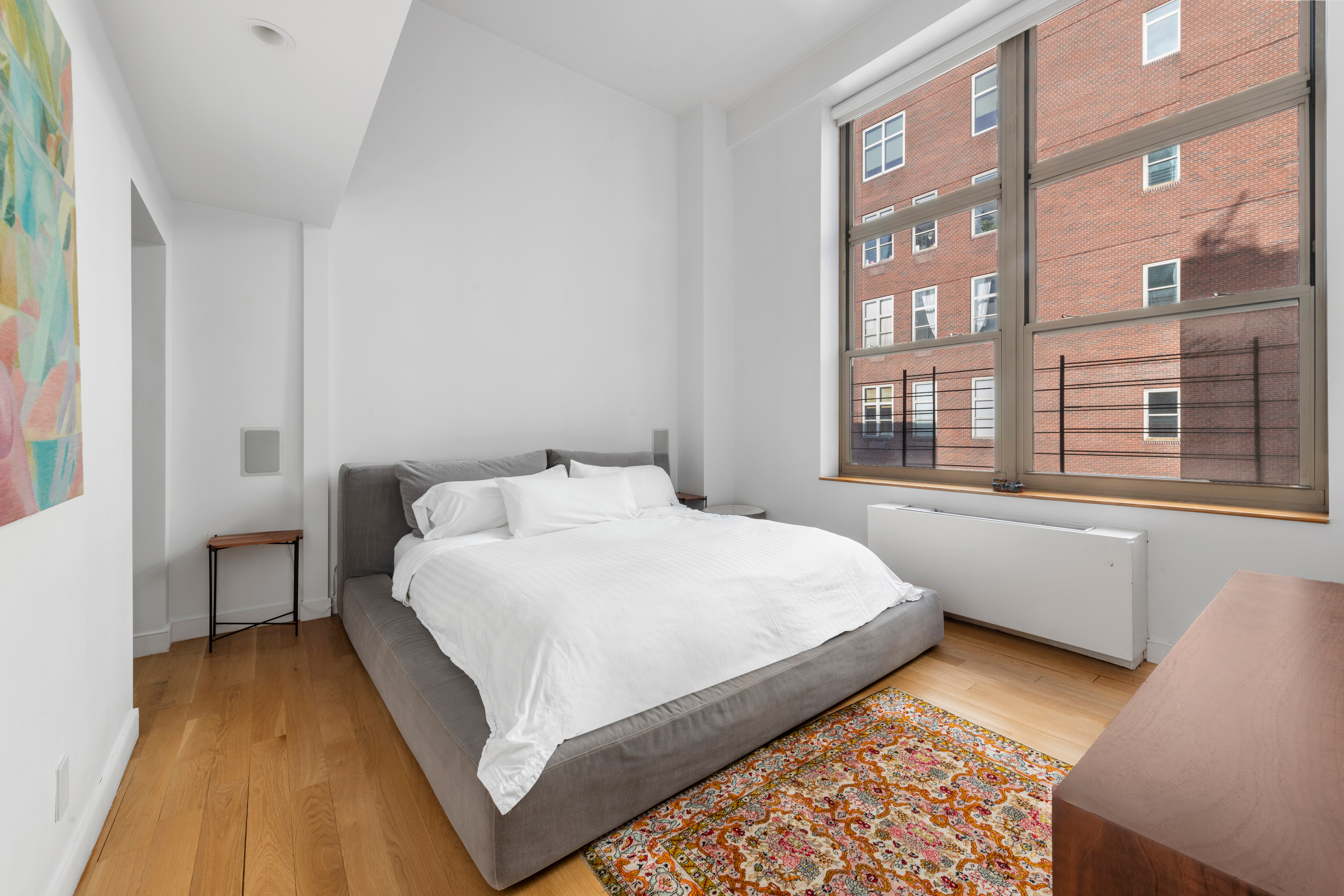 120 East 87th Street, Unit R16G Manhattan, NY 10128 - Photo 7 of 20 a bedroom with a bed and a window