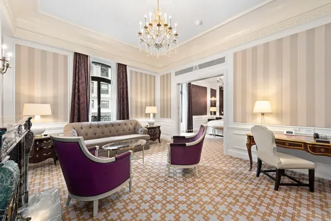 a living room with furniture a rug and a window