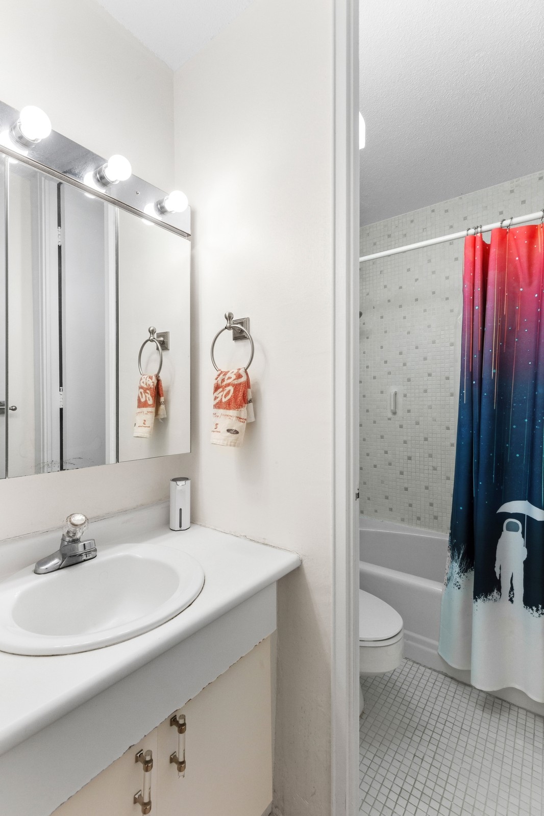 300 East 40th Street, Unit 9V Manhattan, NY 10016 - Photo 4 of 7 a bathroom with a sink a toilet and shower