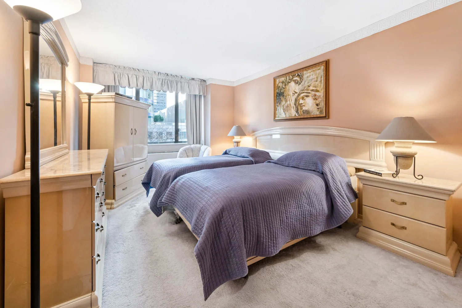 a spacious bedroom with a bed and a lamp