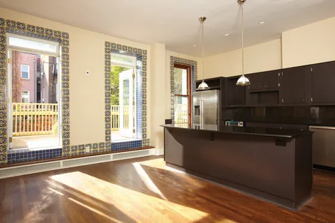 a open kitchen with stainless steel appliances granite countertop a sink a stove and a wooden floors