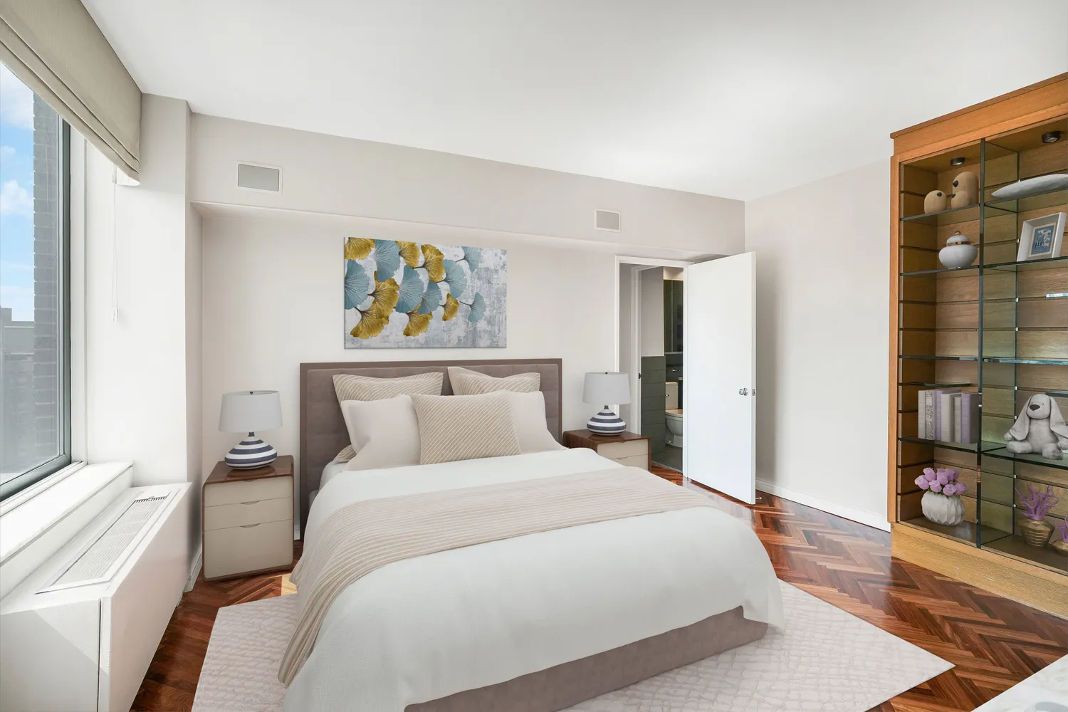 a bedroom with a large bed and a window