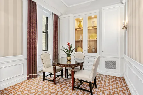 a view of a dining room with furniture and a window