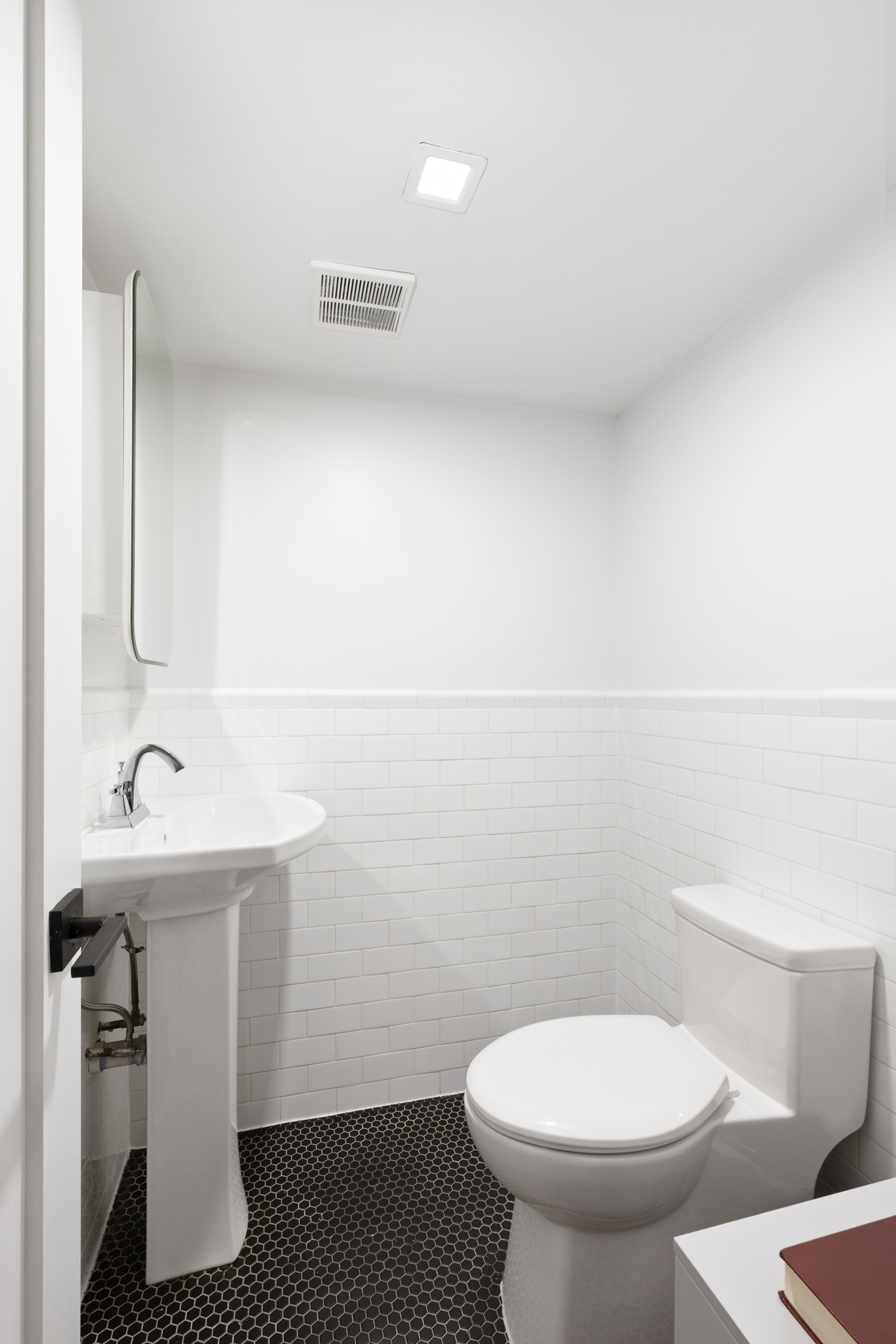 437 Putnam Avenue, Unit 1 Brooklyn, NY 11221 - Photo 10 of 12 a bathroom with a sink a toilet and mirror