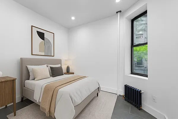 a bedroom with a bed and a window