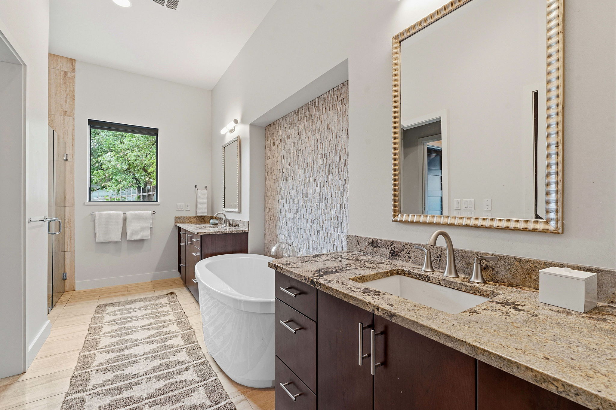 3605 Robbins Road Austin, TX 78730 - Photo 22 of 51 a spacious bathroom with a granite countertop sink and a mirror
