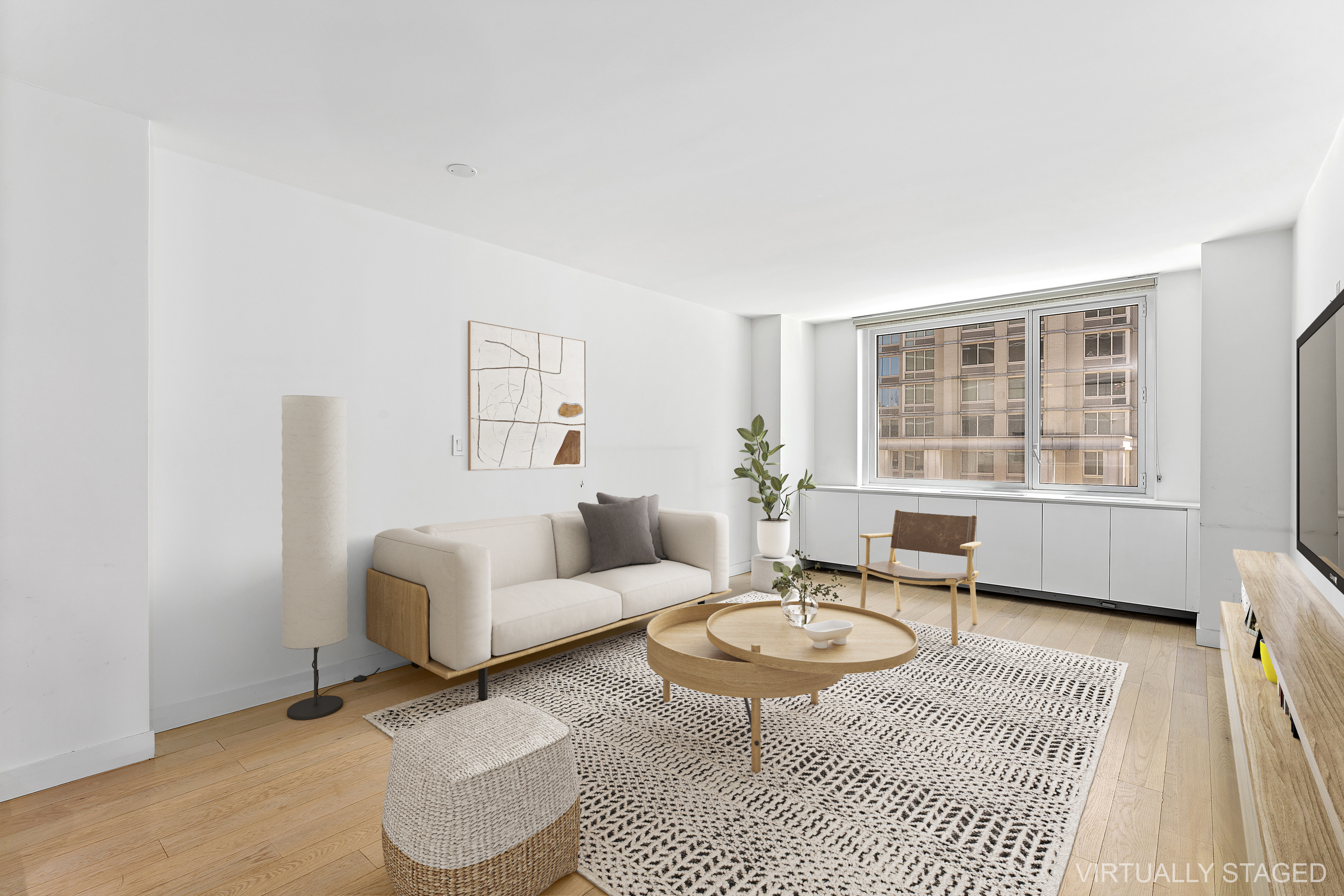 a living room with furniture a rug and a table