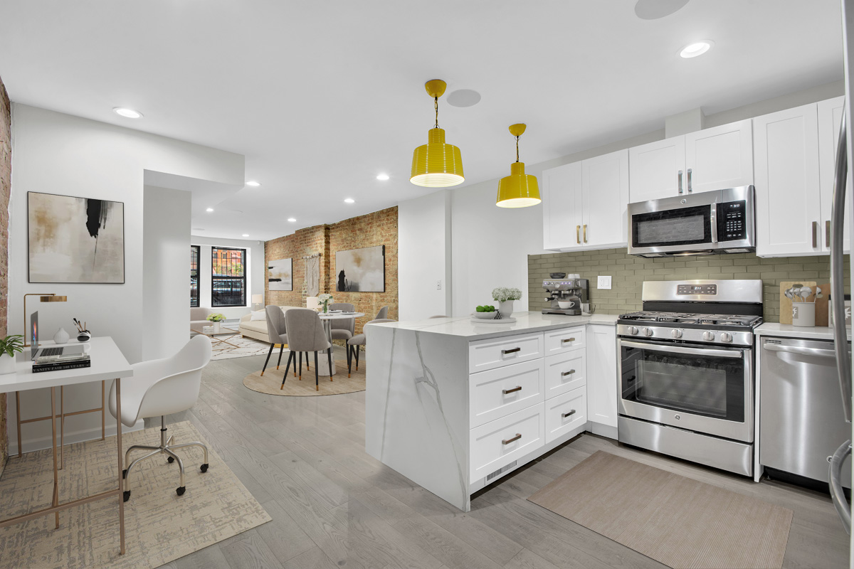 208 West 122nd Street Manhattan, NY 10027 - Photo 17 of 22 a kitchen with stainless steel appliances kitchen island granite countertop a stove a sink a dining table and chairs