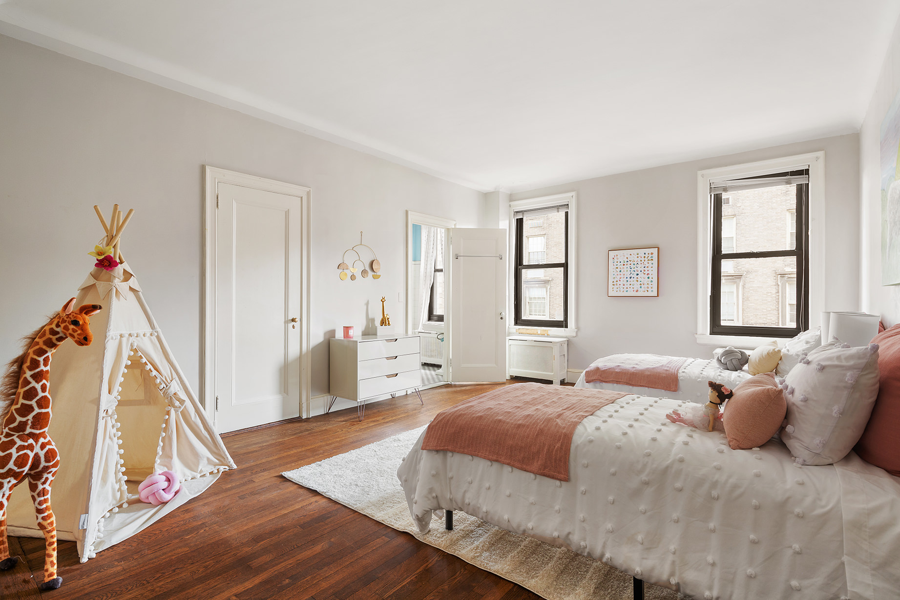 1115 5th Avenue, Unit 5B Manhattan, NY 10128 - Photo 13 of 19 a bedroom with a bed and wooden floor