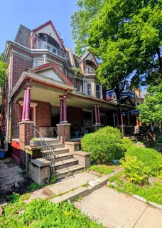 a front view of a house with a garden and plants