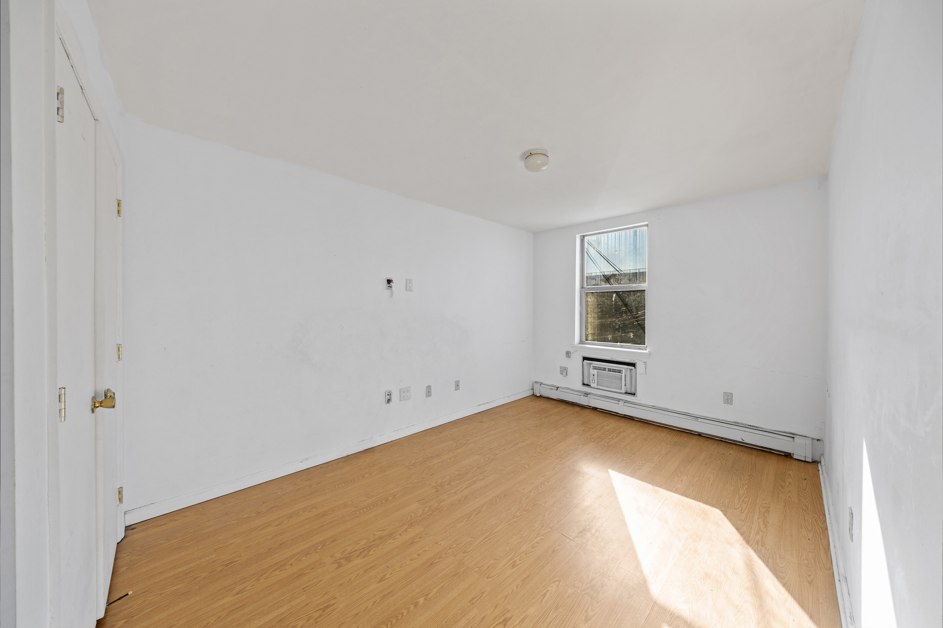 2028 Bergen Street, Unit 1 Brooklyn, NY 11233 - Photo 6 of 9 a view of an empty room with a window