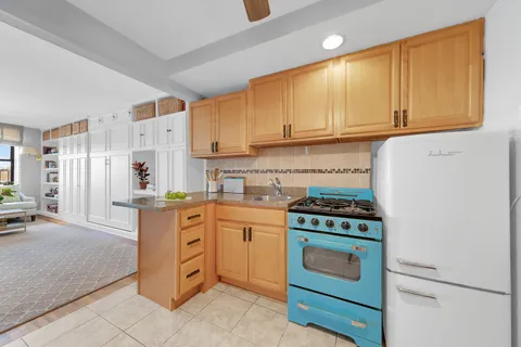 a kitchen with stainless steel appliances granite countertop a stove and a refrigerator