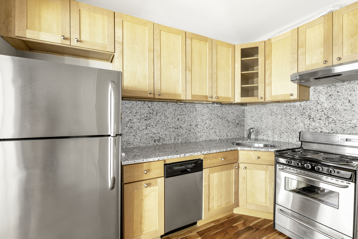 21 Downing Street, Unit 4 Manhattan, NY 10014 - Photo 3 of 6 a kitchen with stainless steel appliances a refrigerator sink and cabinets