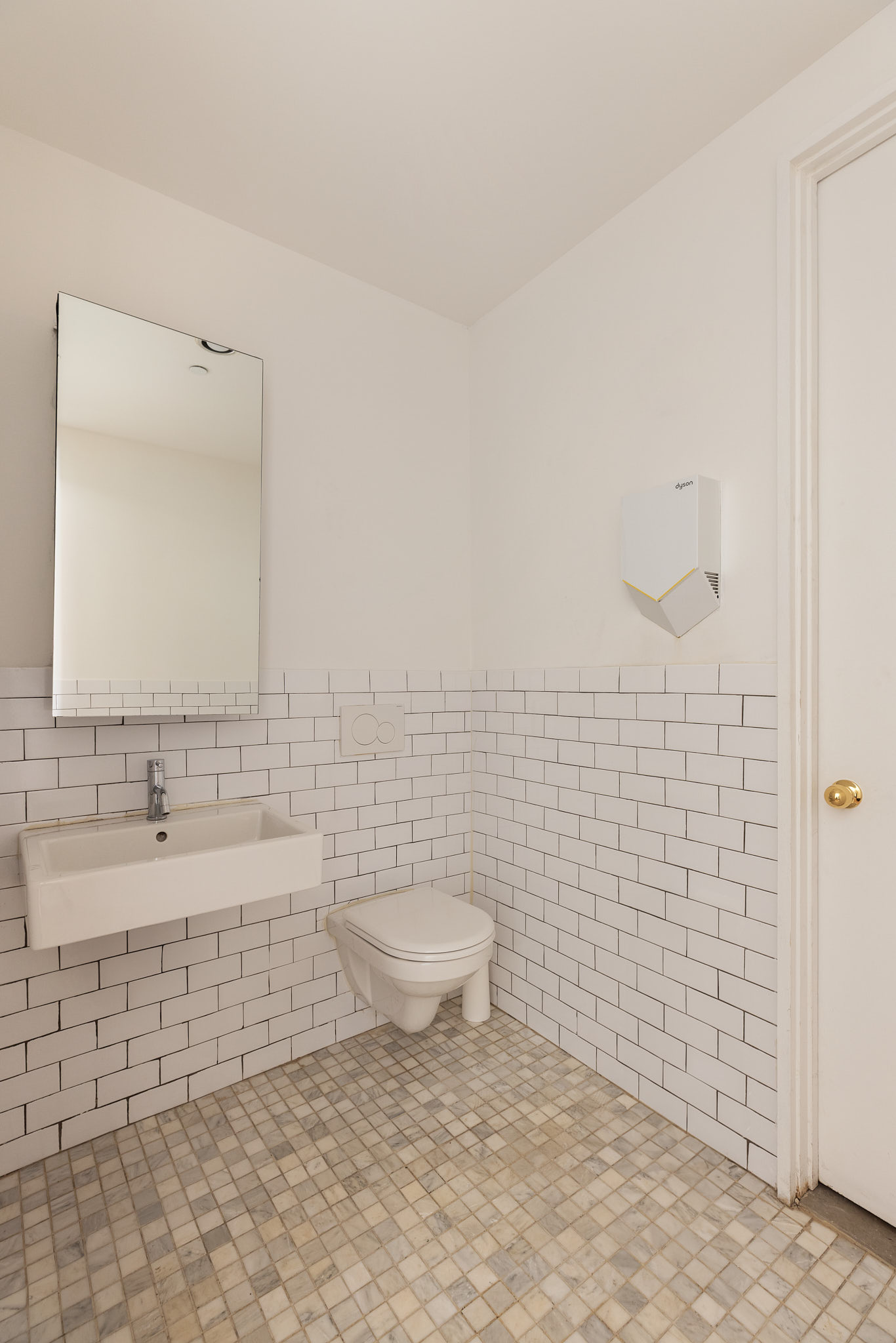 136 Baxter Street, Unit 1B Manhattan, NY 10013 - Photo 8 of 12 a bathroom with a toilet a sink and mirror