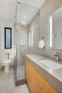 a bathroom with a double vanity sink mirror and toilet