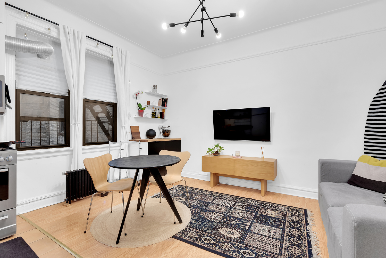 166 East 92nd Street, Unit 1D Manhattan, NY 10128 - Photo 3 of 6 a living room with furniture and a flat screen tv