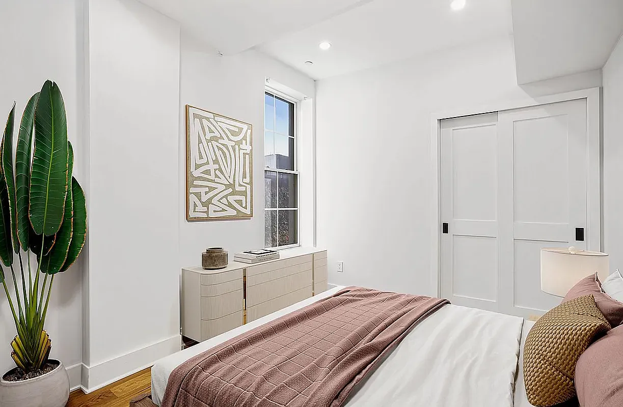 25 Lexington Avenue, Unit 202 Brooklyn, NY 11238 - Photo 5 of 7 a bedroom with a bed and a potted plant