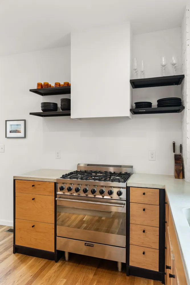 a stove top oven sitting inside of a kitchen
