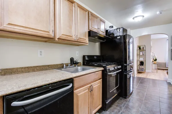 a kitchen with stainless steel appliances granite countertop a stove and a sink