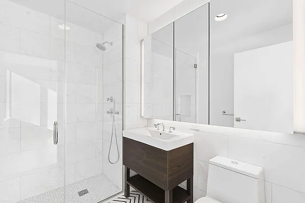 100 Avenue A, Unit 4E Manhattan, NY 10009 - Photo 4 of 5 a bathroom with a sink a toilet and shower