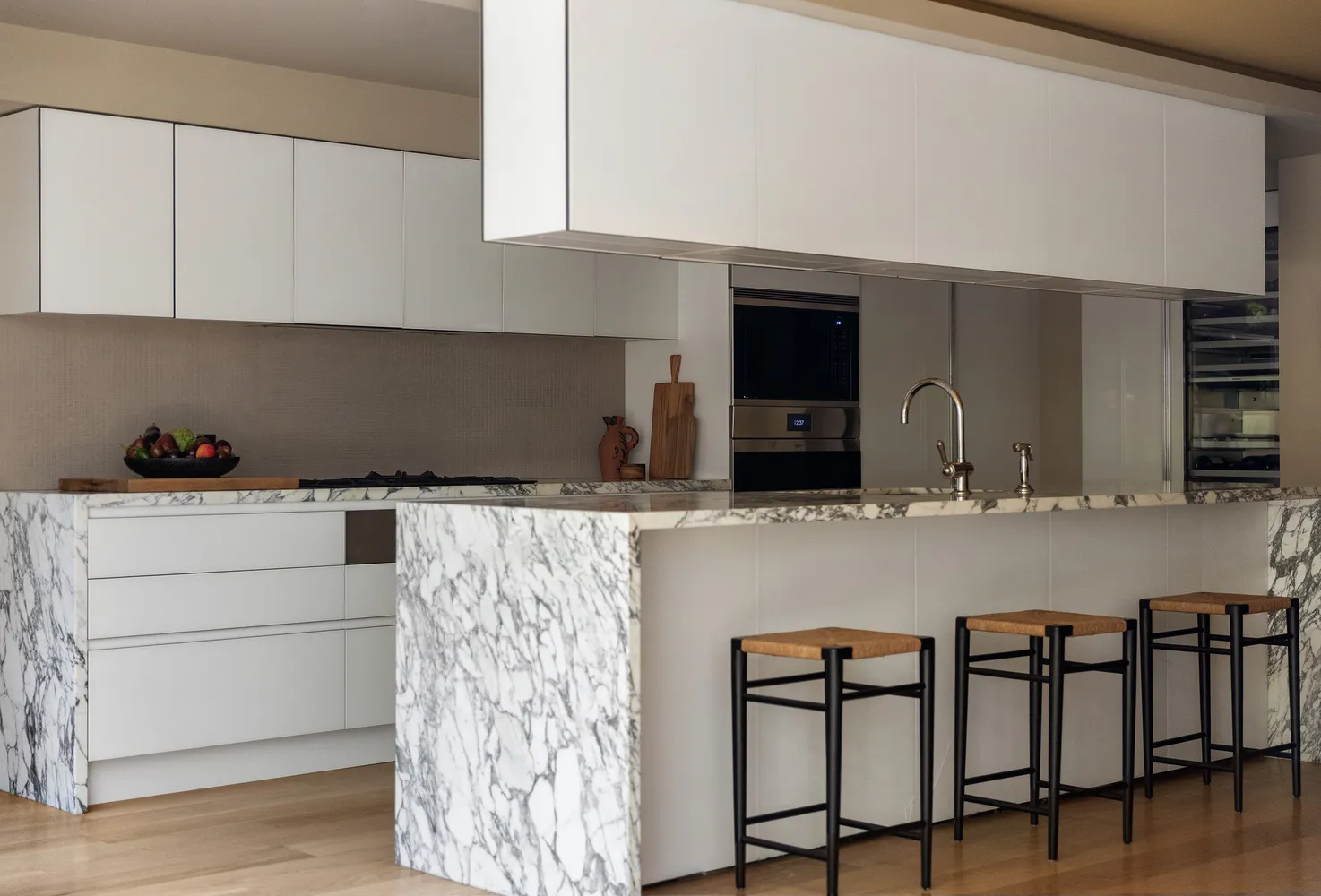 a kitchen with a table chairs window and cabinets