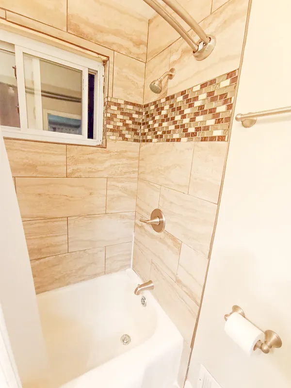 a bathroom with a bathtub and shower