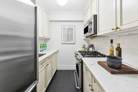 a kitchen with stainless steel appliances granite countertop a sink and a stove
