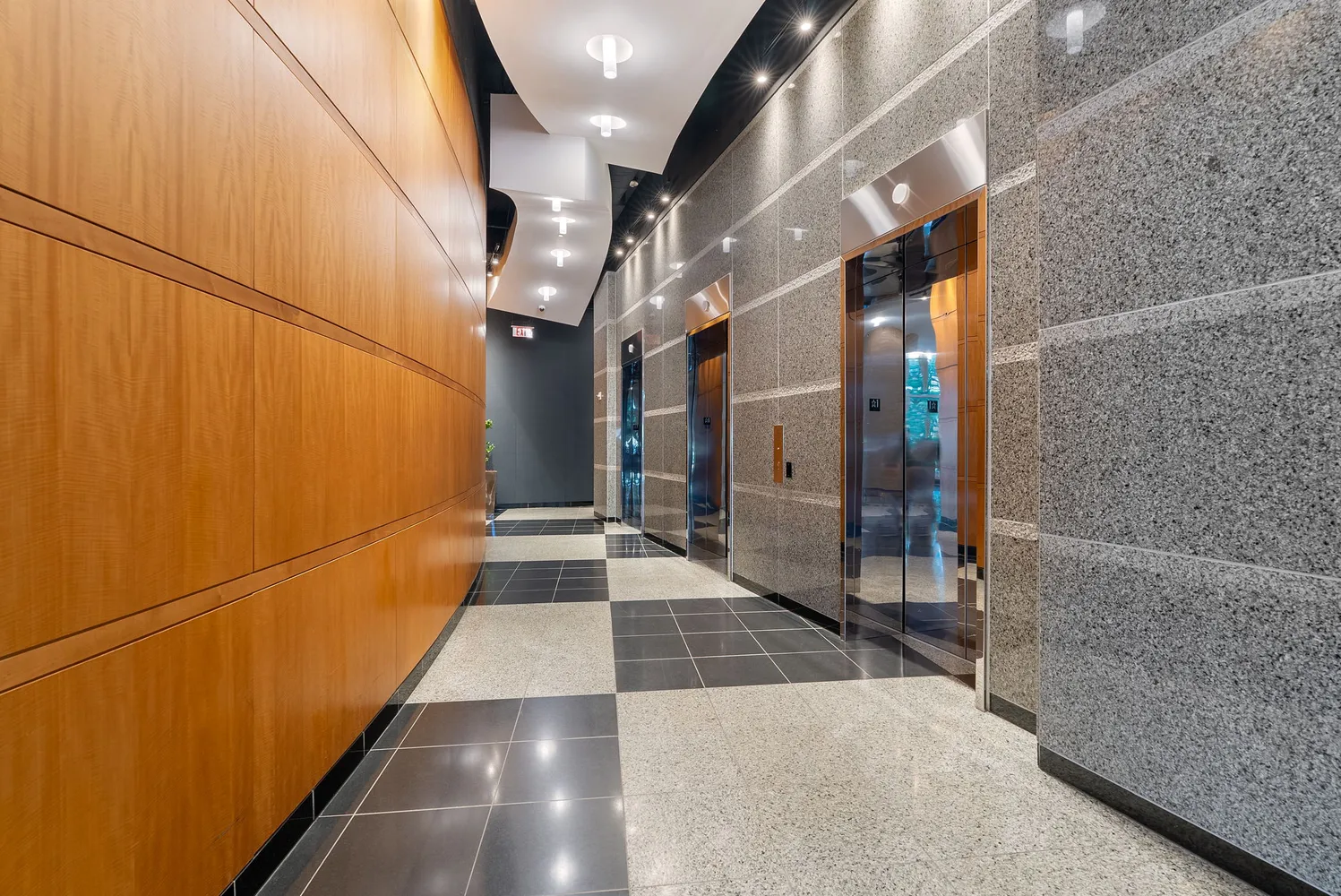 a view of a livingroom with wooden floor and cabinets