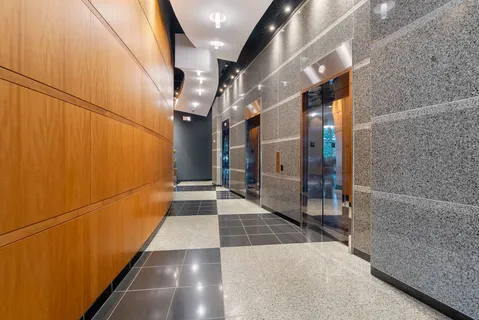 a view of a livingroom with wooden floor and cabinets