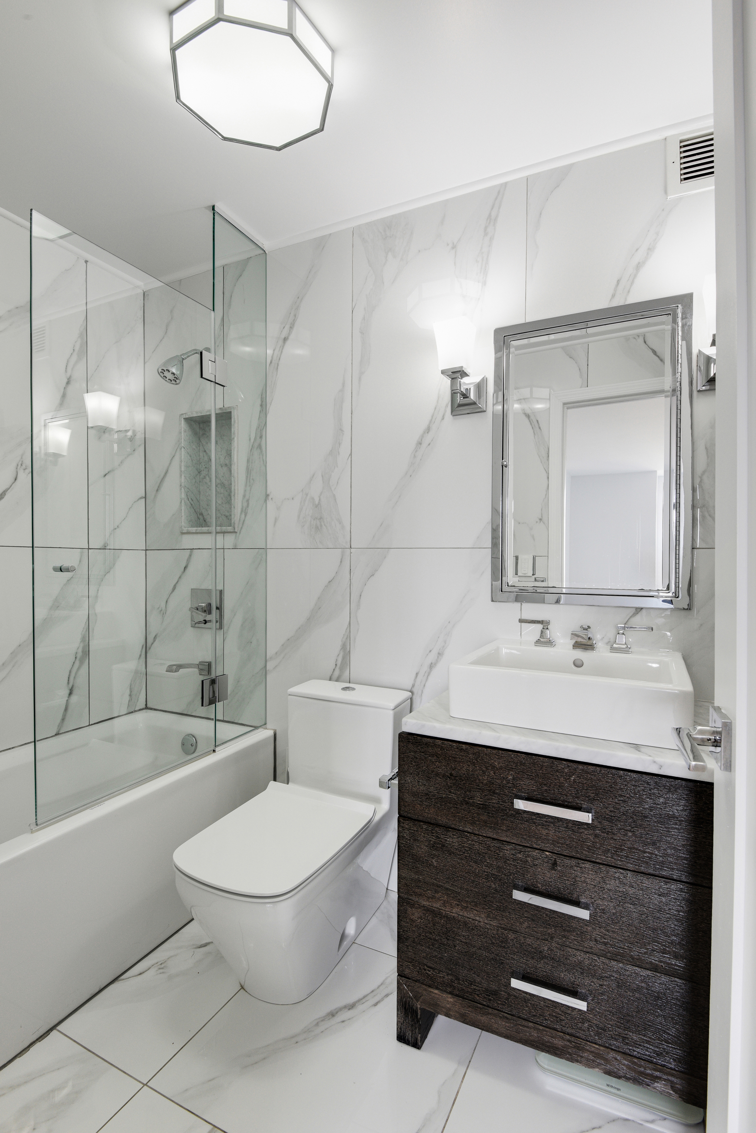 400 East 70th Street, Unit 3005 Manhattan, NY 10021 - Photo 11 of 18 a bathroom with a sink a toilet and shower