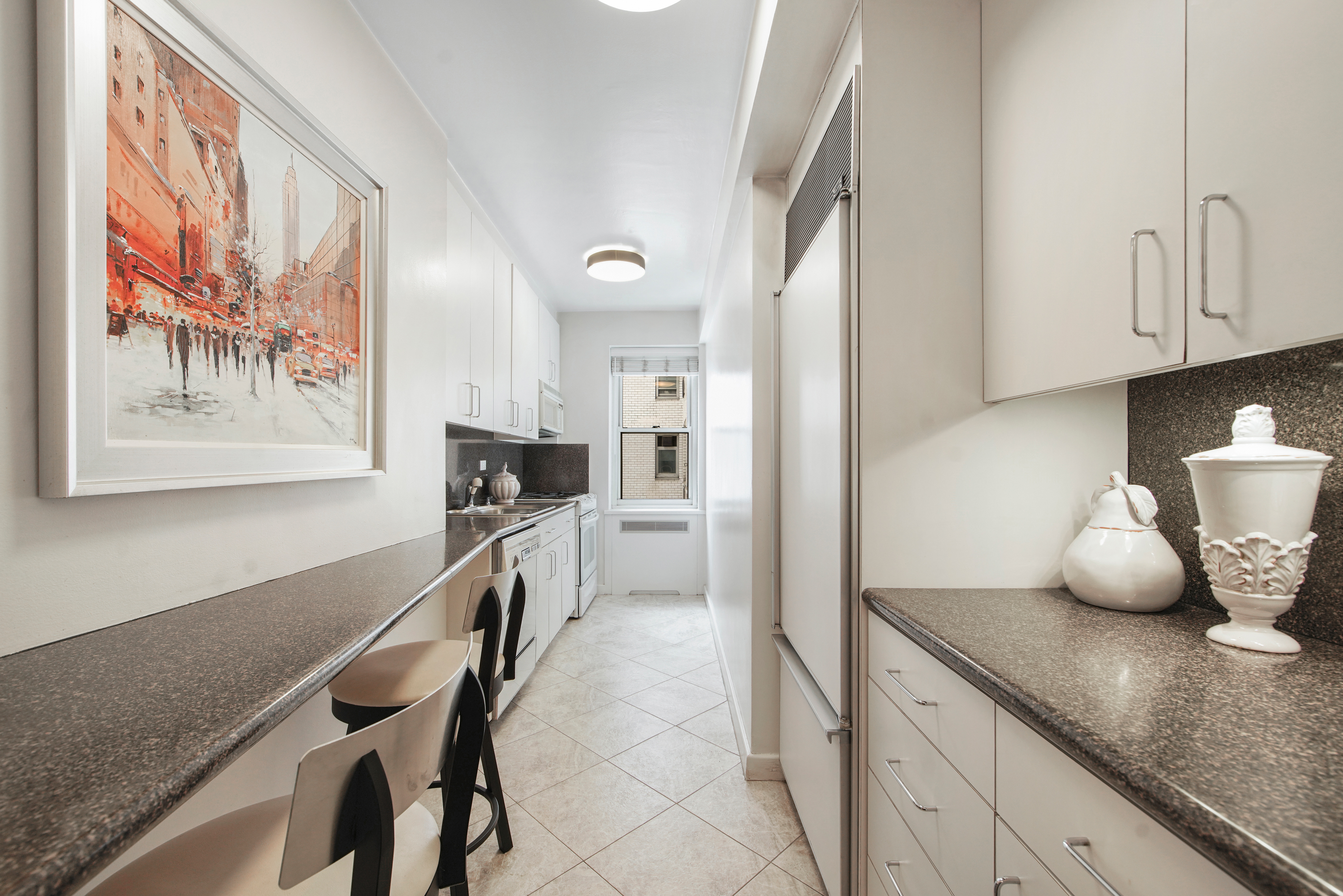 45 Sutton Place South, Unit 9O Manhattan, NY 10022 - Photo 7 of 16 a kitchen with cabinets and window