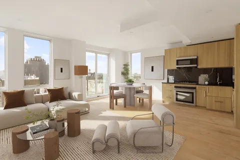 a living room with furniture wooden floor and a kitchen view