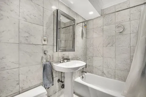 a bathroom with a sink shower and a bathtub