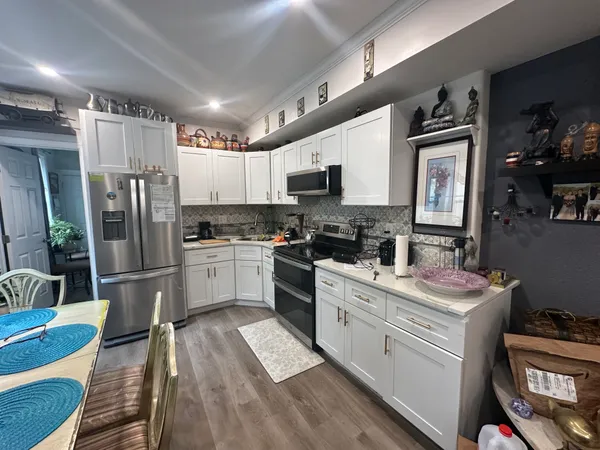 a kitchen with stainless steel appliances granite countertop a refrigerator sink and stove