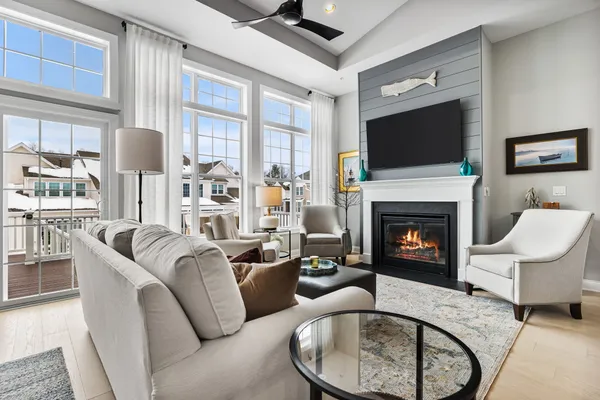 a living room with furniture a flat screen tv and a fireplace