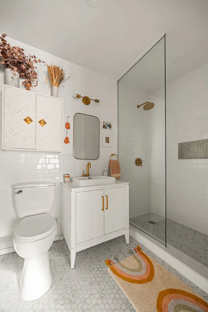 a bathroom with a sink toilet and shower