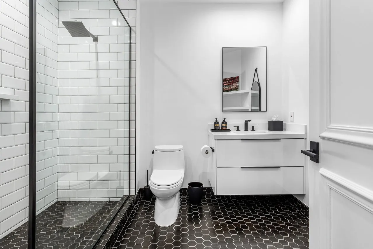 a bathroom with a sink toilet and shower