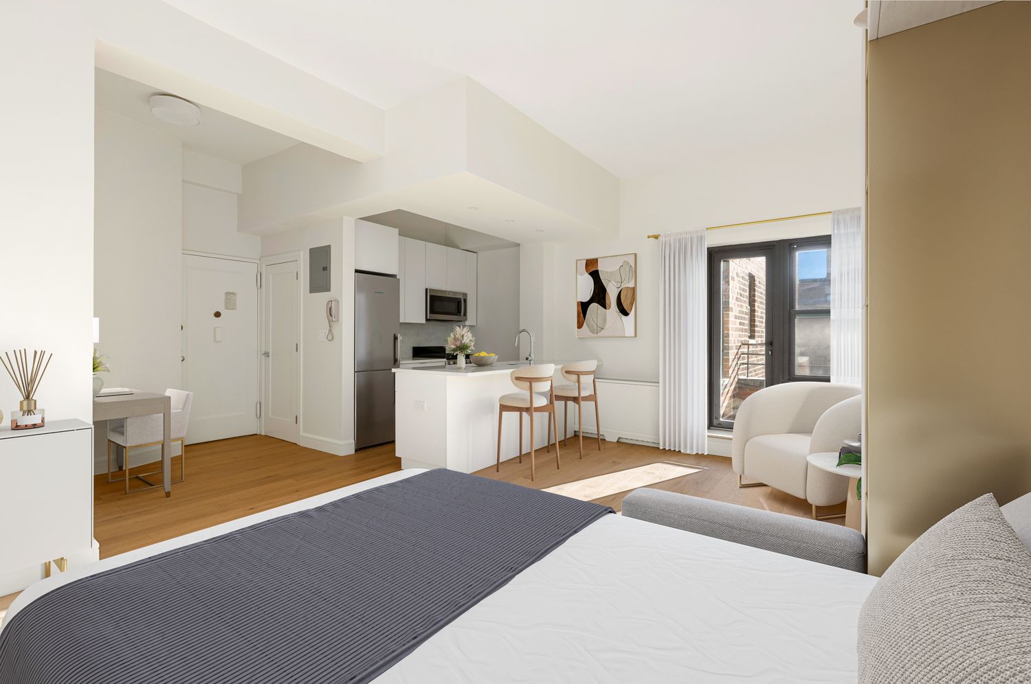 11 Riverside Drive, Unit 17E Manhattan, NY 10023 - Photo 5 of 16 a bedroom with a bed and white cabinets