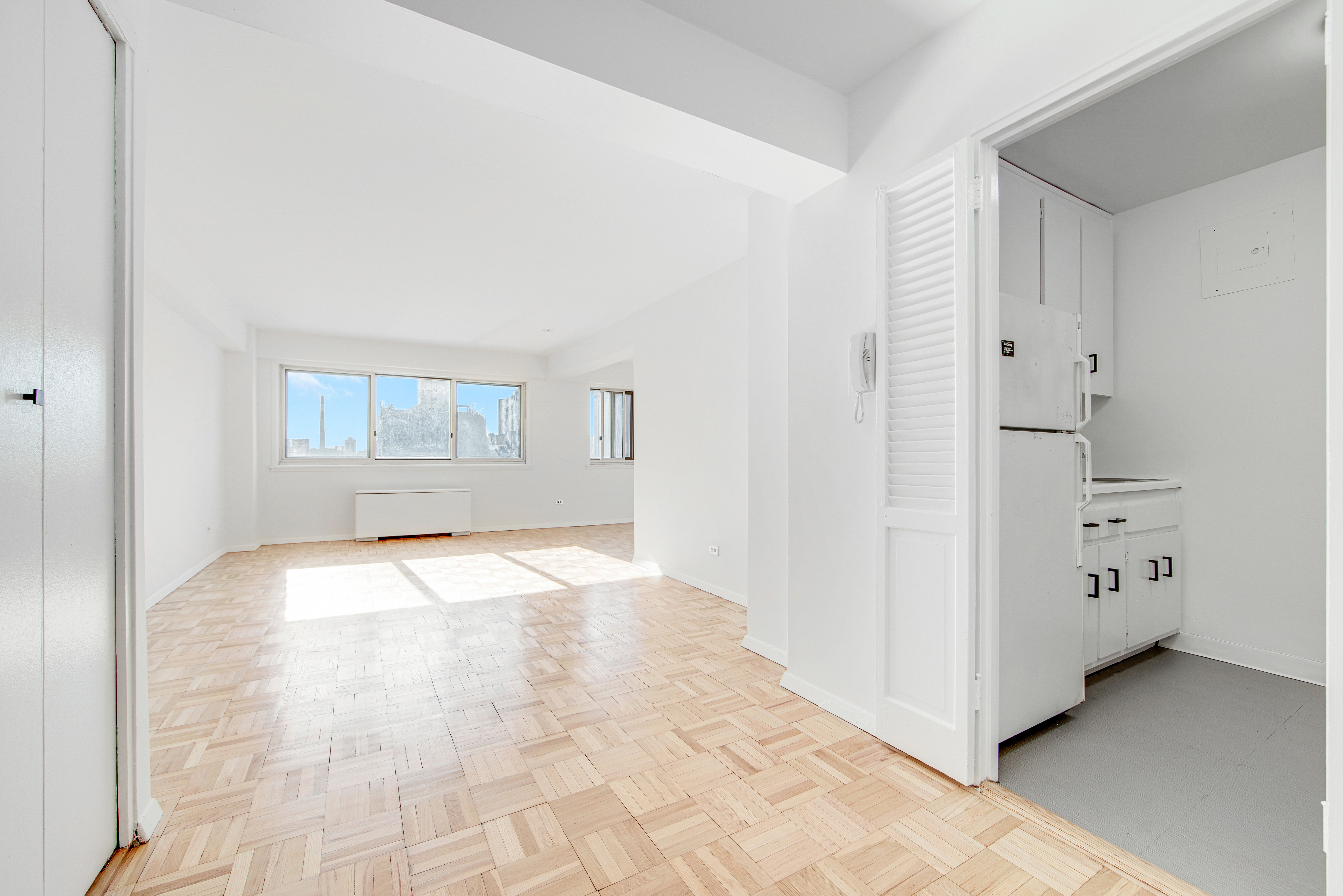 401 East 65th Street, Unit 10H Manhattan, NY 10065 - Photo 6 of 14 an empty room with windows