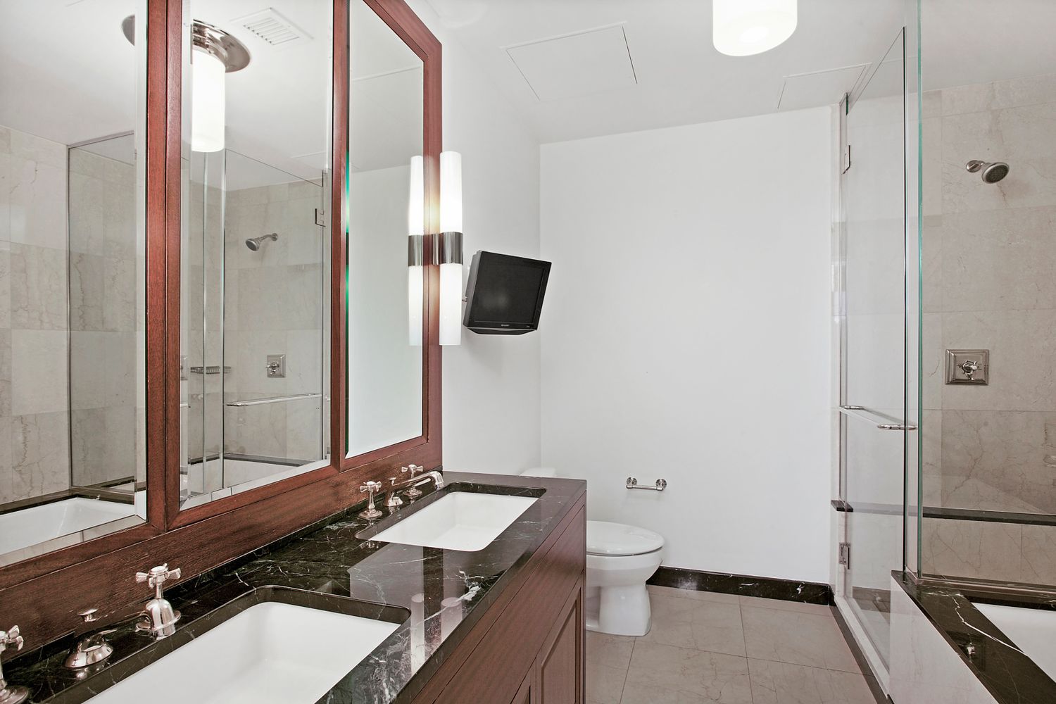 55 Wall Street, Unit PH910 Manhattan, NY 10005 - Photo 9 of 11 a bathroom with a sink and a mirror