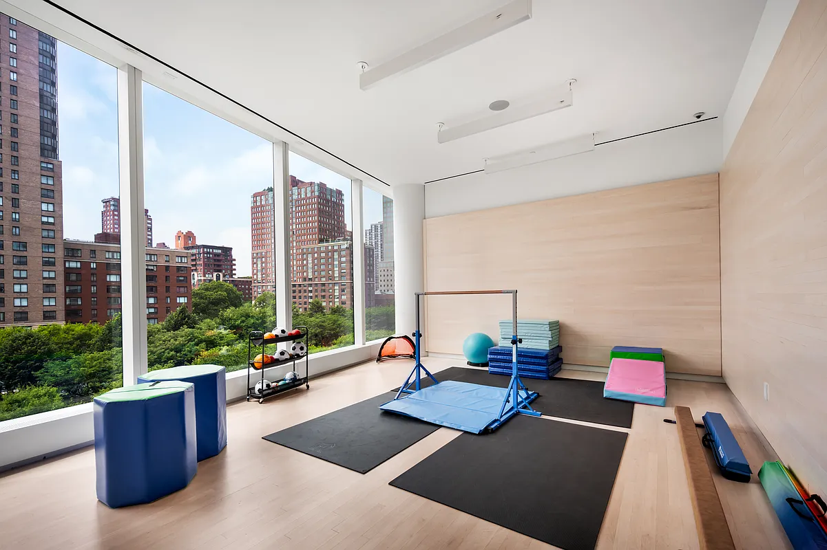 50 West Street, Unit 30B Manhattan, NY 10006 - Photo 22 of 25 a living room with furniture and a potted plant
