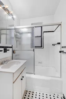 a bathroom with a sink a mirror and a bathtub