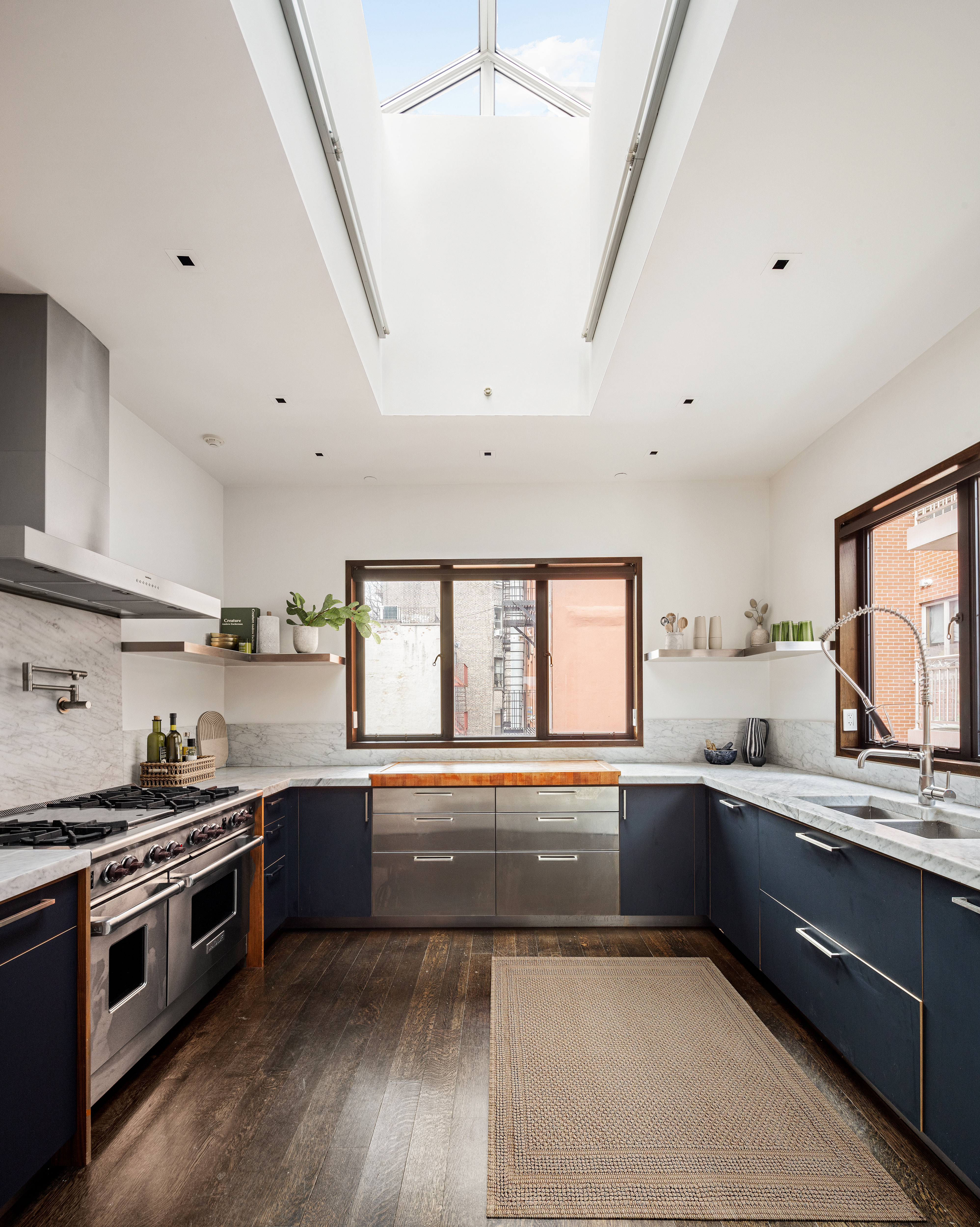 35 Spring Street Manhattan, NY 10012 - Photo 4 of 14 a large kitchen with stainless steel appliances a stove a sink and a large window