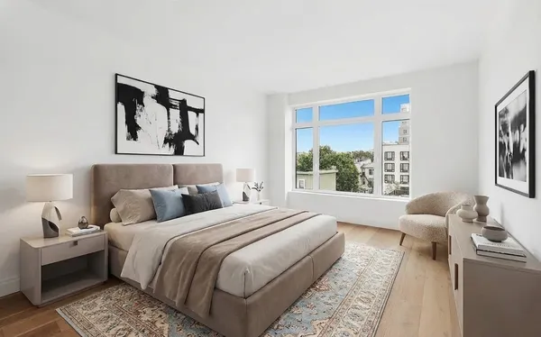 a bedroom with a bed and a large window