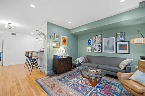 a living room with furniture and wooden floor