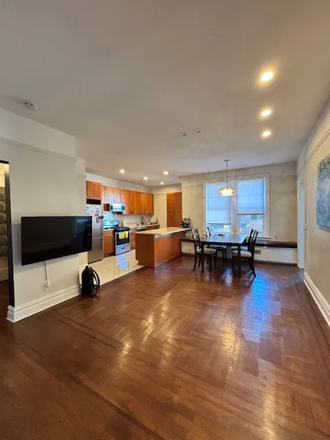 a view of a living room with kitchen and furniture