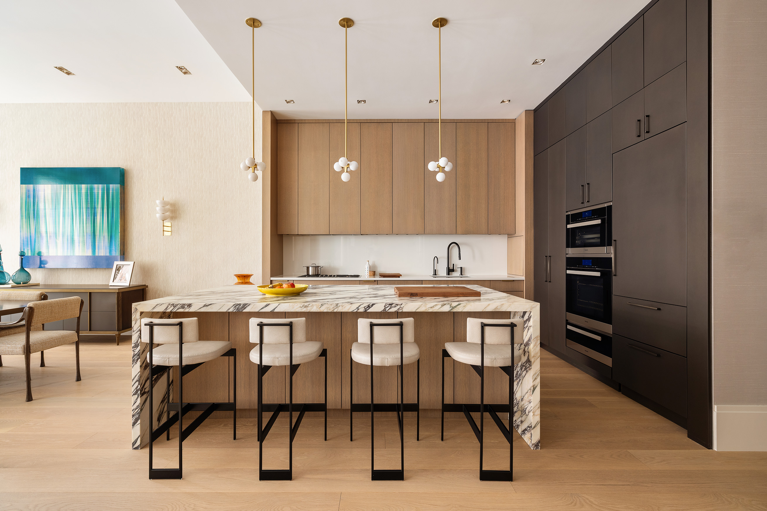 53 Greene Street, Unit 3 Manhattan, NY 10013 - Photo 7 of 22 a dining hall with stainless steel appliances kitchen island granite countertop furniture and a refrigerator