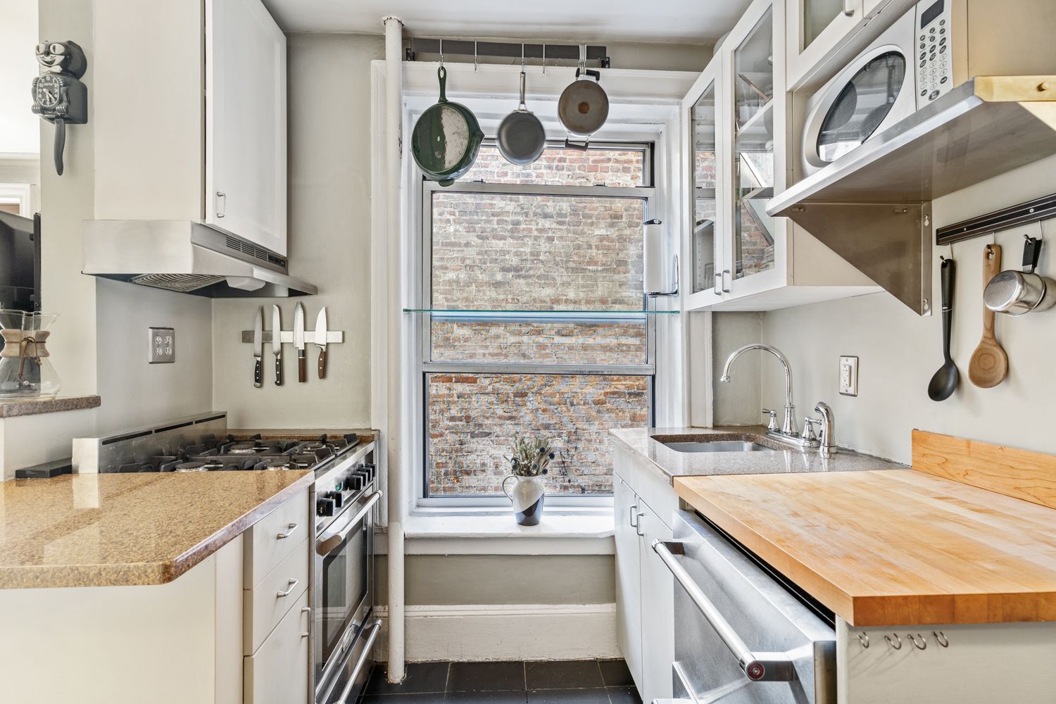 104 Bedford Street, Unit 4C Manhattan, NY 10014 - Photo 5 of 9 a kitchen with a stove and a white refrigerator